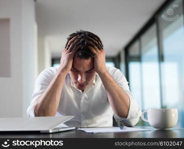 frustrated with problems young business man working on laptop computer at home