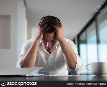 frustrated with problems young business man working on laptop computer at home