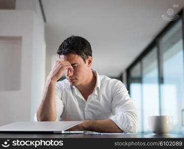 frustrated with problems young business man working on laptop computer at home