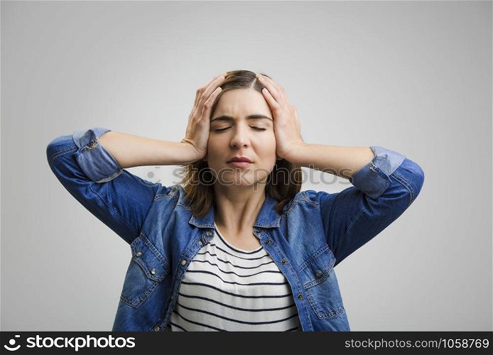 Frustrated woman holding head in hands and expressing pain
