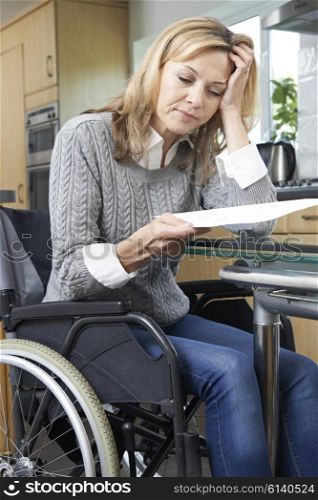 Frustrated Woman In Wheelchair Reading Letter