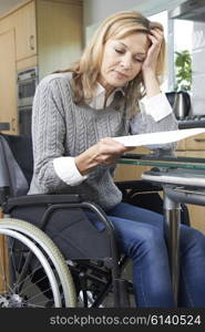 Frustrated Woman In Wheelchair Reading Letter