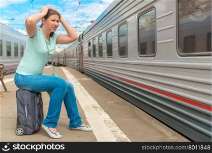 frustrated woman looking at the passing train on which she was late