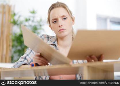 frustrated woman trying to fix something