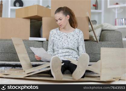 frustrated woman with self assembly furniture in kitchen