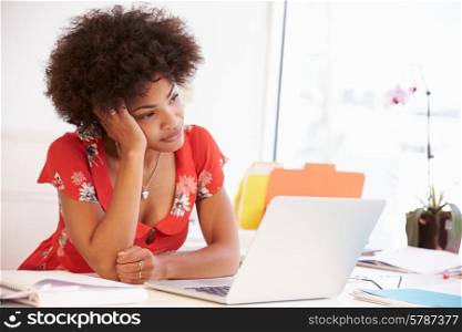 Frustrated Woman Working At Desk In Design Studio