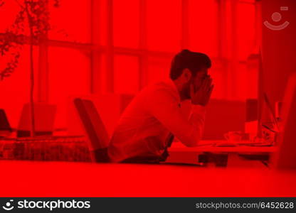 frustrated young business man working on desktop computer at modern startup office interior