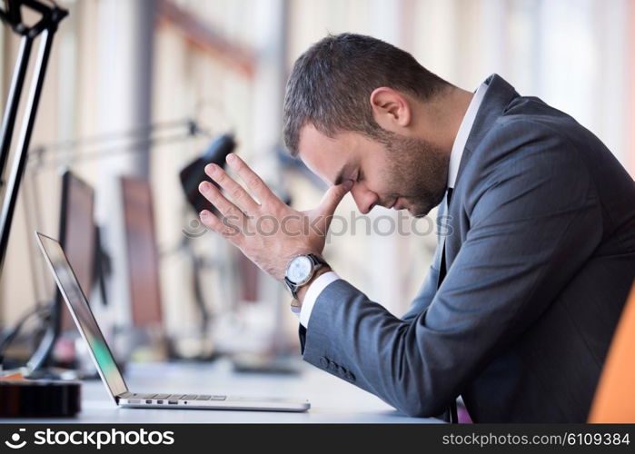 frustrated young business man working on laptop computer at office