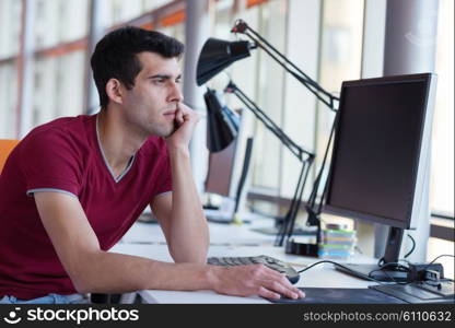 frustrated young business man working on laptop computer at office