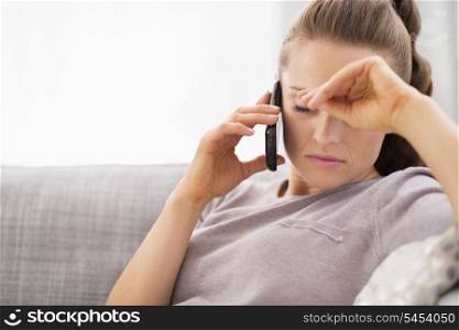 Frustrated young woman talking cell phone