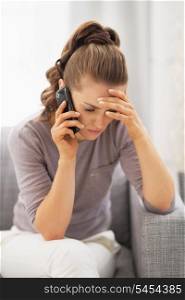 Frustrated young woman talking mobile phone