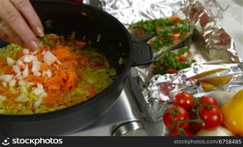 frying carrot and onion for baked fish