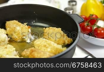 frying chicken breast roll on a pan.