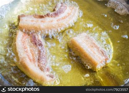 Frying crispy pork belly on hot oil