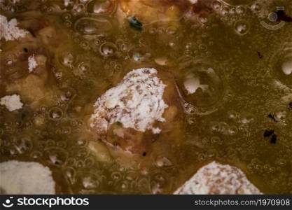 Frying meatballs in pan with oil