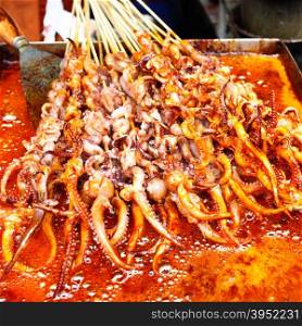 Frying of squid&rsquo;s tentacles skewers in Shanghai, China