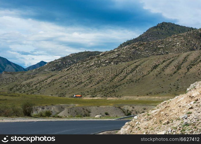 Fuel tanker track driving on the mountain road in Altai. Fuel tanker track driving