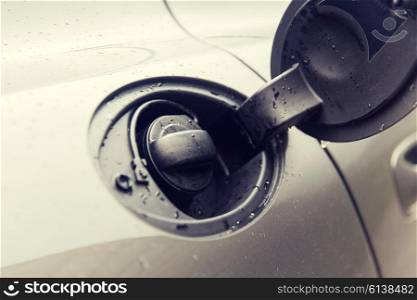 fueling, motor vehicle, transportation and driving concept - close up of car open fuel tank
