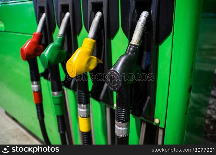 Fueling nozzles in different colors on green bright station
