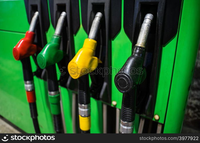 Fueling nozzles in different colors on green bright station