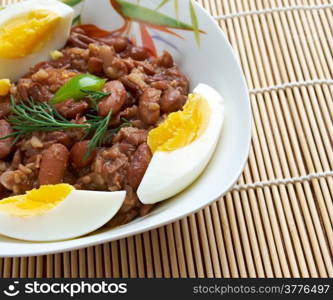 Ful medames - Egyptian,Sudanese dish of cooked and mashed fava beans served with vegetable oil,