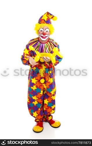 Full body isolated view of a birthday clown holding a balloon animal.