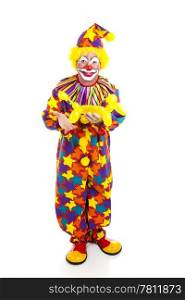 Full body isolated view of a birthday clown holding a balloon animal.
