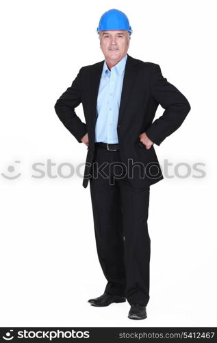 full-body picture of mature architect with arms akimbo