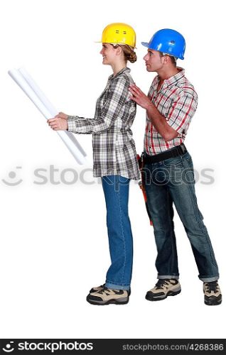 full-body picture of young female architect and male builder against white background