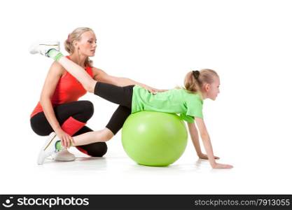 Full body shot of a little girl doing exercise with an instructor. Orange, green and black colors