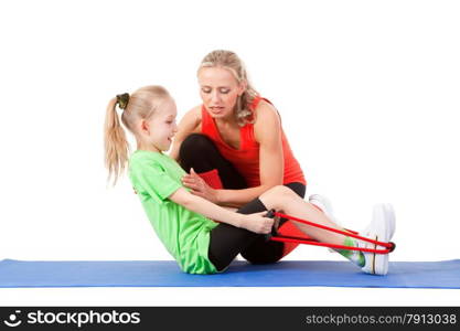 Full body shot of a little girl doing exercise with weights with an instructor on the mat . Orange, green and black colors