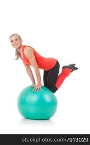 Full body shot of a smiling woman sitting on her knees and balancing on the fitness ball. Orange, green and black colors