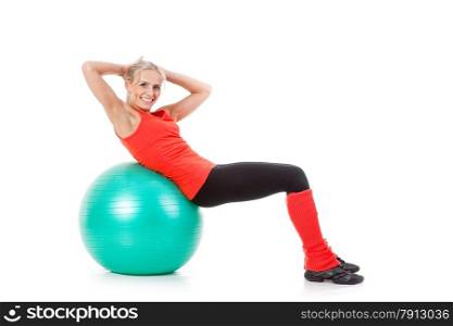 Full body shot of a woman doing exercises with pilates ball. Orange, green and black colors