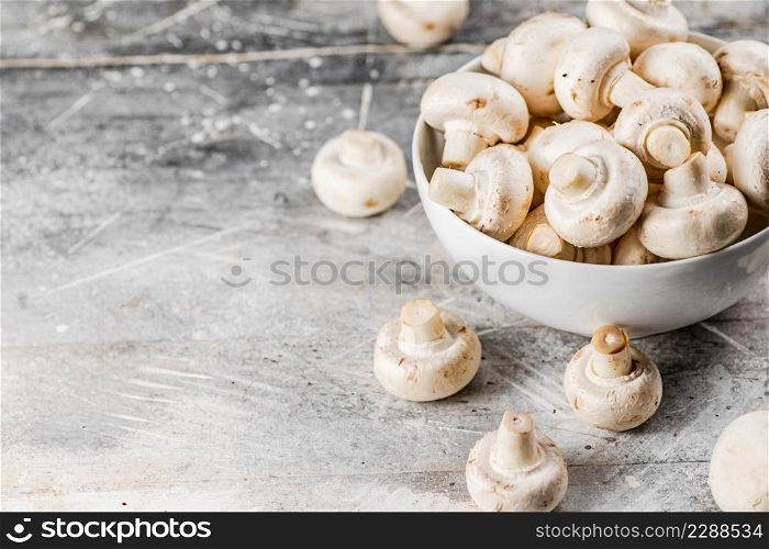 Full bowl with mushrooms on the table. On a gray background. High quality photo. Full bowl with mushrooms on the table.