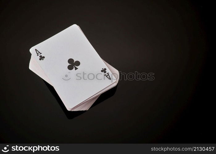 Full deck of playing cards with ace on top on dark reflective background.. Full deck of playing cards with ace on top on dark reflective background