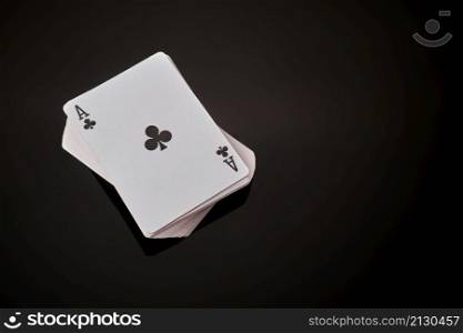 Full deck of playing cards with ace on top on dark reflective background.. Full deck of playing cards with ace on top on dark reflective background