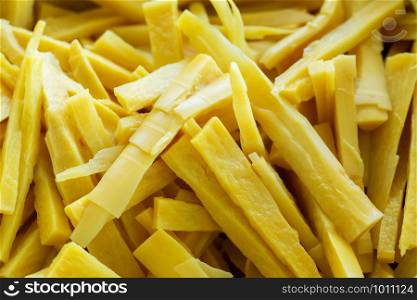 Full frame photo of bamboo shoots cut into pieces.