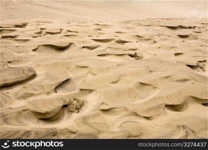Full frame view of swirled, pitted sand dunes