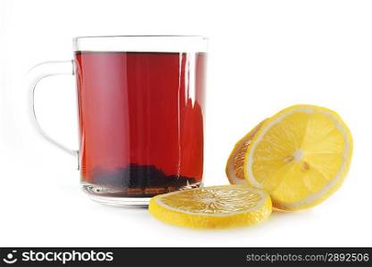 Full glass cup of tea and lemon close up