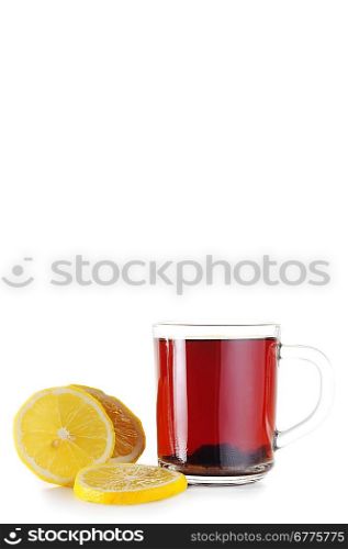 Full glass cup of tea and lemon close up