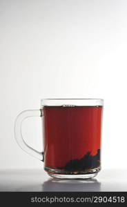 Full glass cup of tea isolated