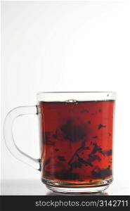Full glass cup of tea isolated