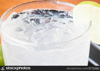 Full glass of fresh cool soda with lime fruit
