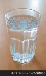 Full glass of water glass on a wooden table
