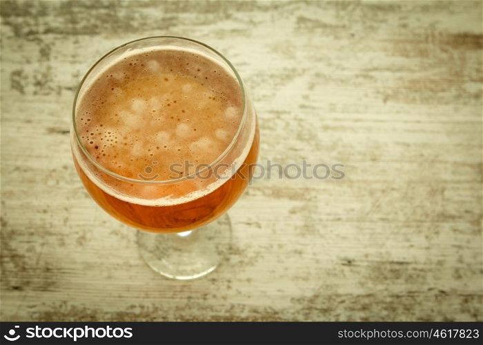 Full lager beer cup on a wooden table