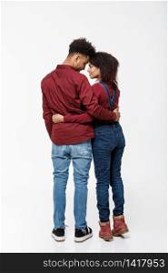 Full lenght back view of young African American couple hugging together isolated on white background.. Full lenght back view of young African American couple hugging together isolated on white background