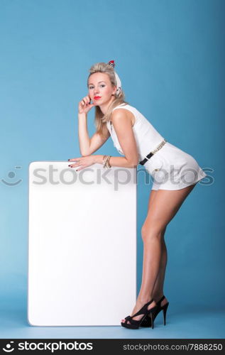 full lenght Beautiful young woman with pin-up make-up and hairstyle posing in studio with white board.