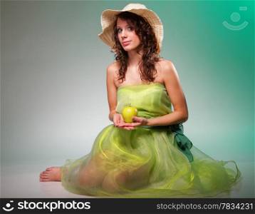 Full length beautiful spring woman with apple. Green or dieting concept. Healthy eating