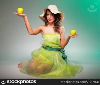 Full length beautiful spring woman with apple. Green or dieting concept. Healthy eating