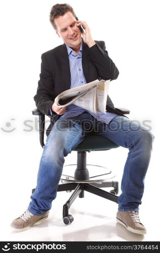 Full length businessman reads newspaper phoning talking on mobile phone commenting economy news isolated on white background